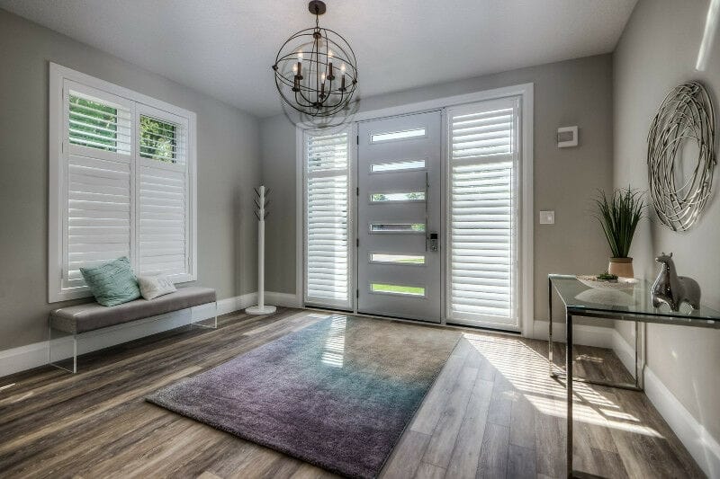 Modern entryway with grey walls and white trim