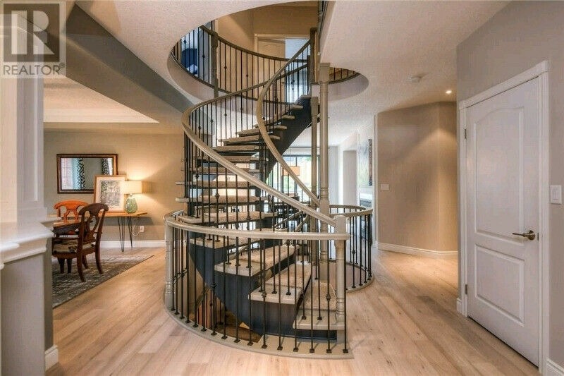 Grand foyer with spiral staircase and neutral tones