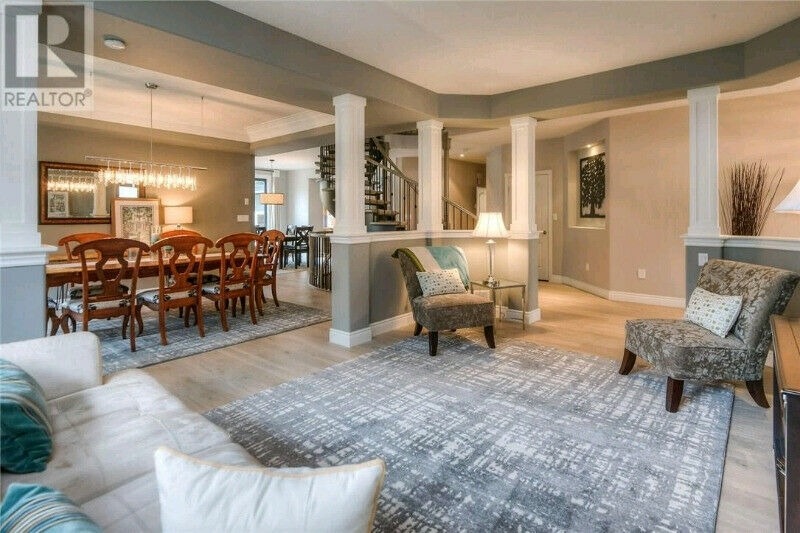 Open concept living and dining room with warm grey walls