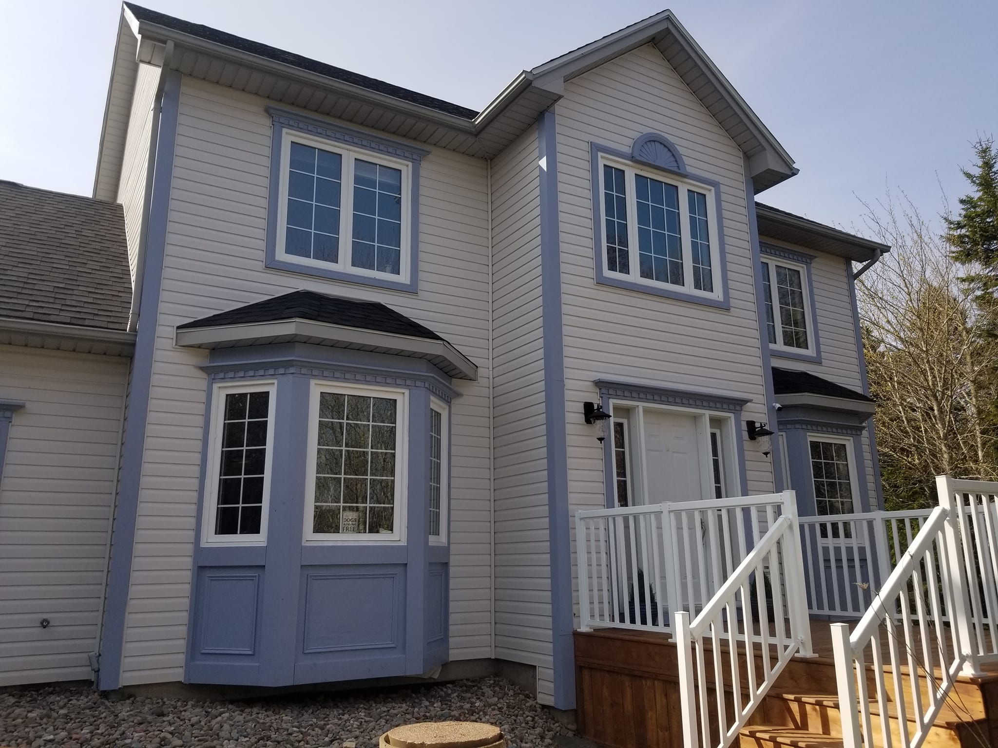 Blue and white two-story exterior house painting