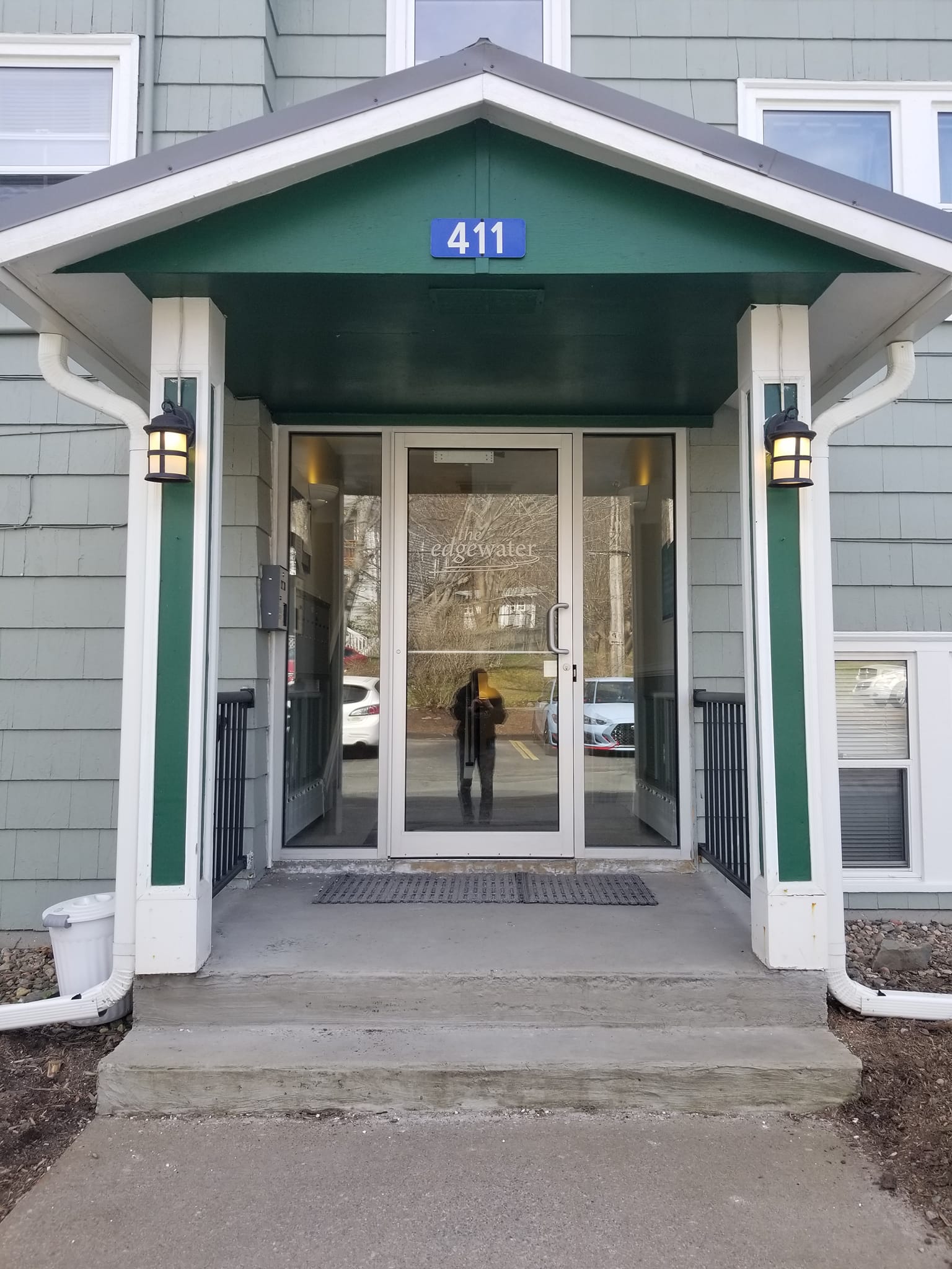 Freshly painted building entrance with green awning