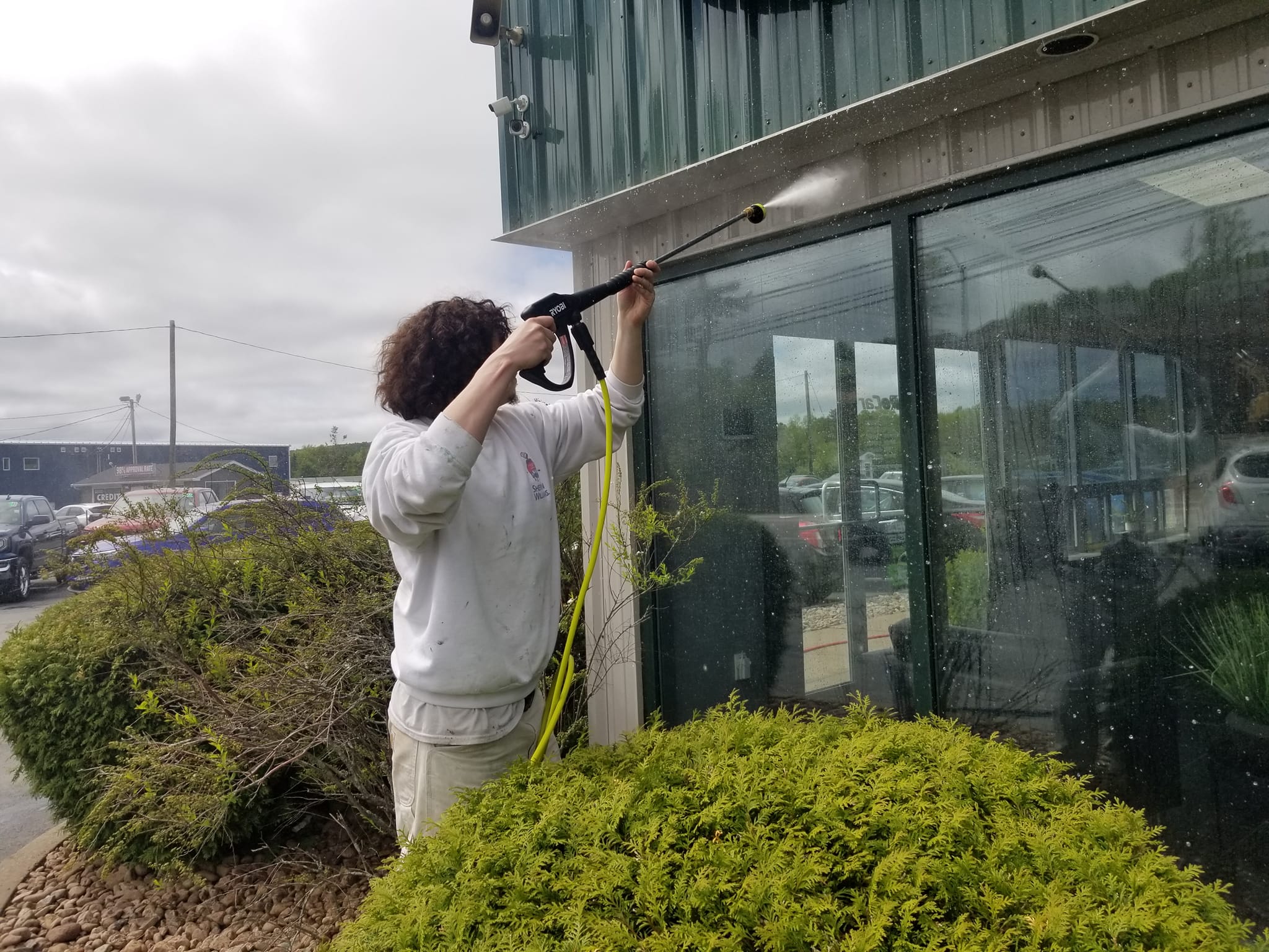 Pressure washing building exterior before painting