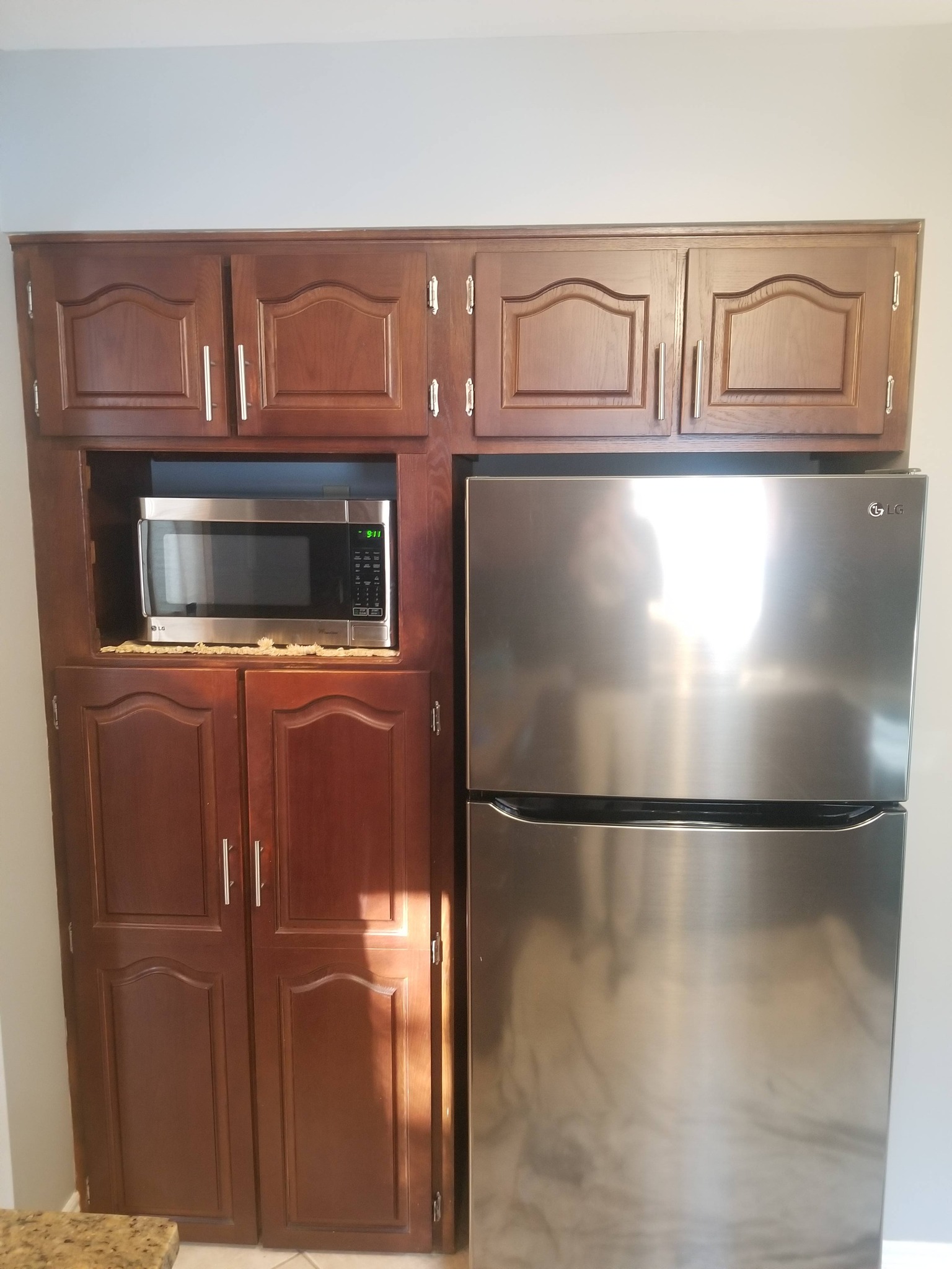 Before: Original dark wood cabinets