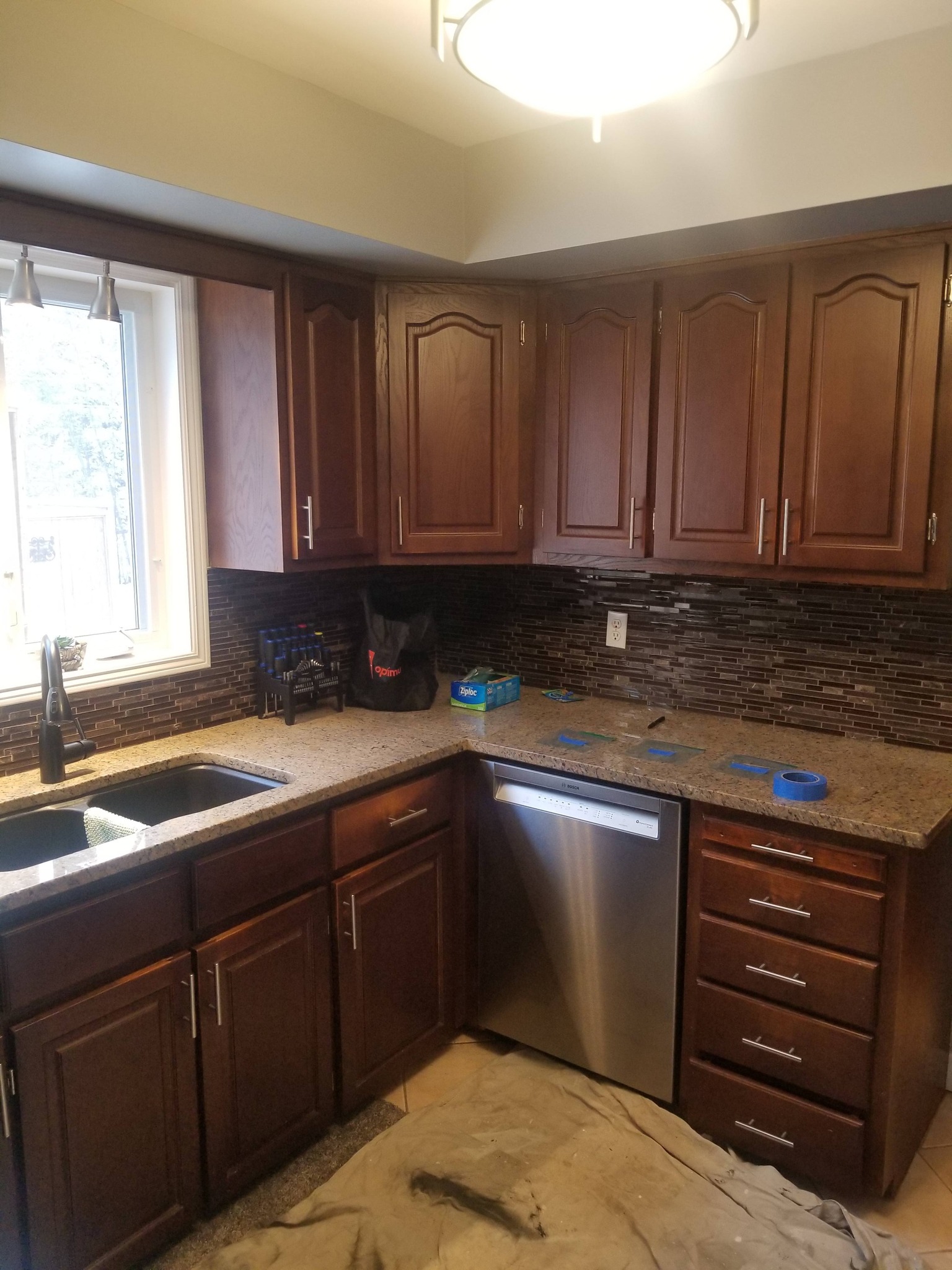 Before: Kitchen with dark stained cabinets